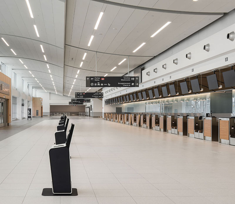 The check-in lobby includes both counters and self-service kiosks.