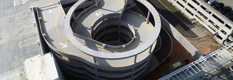 One double-strand helix provides vertical circulation for rental customers; another on the opposite corner serves the general public.